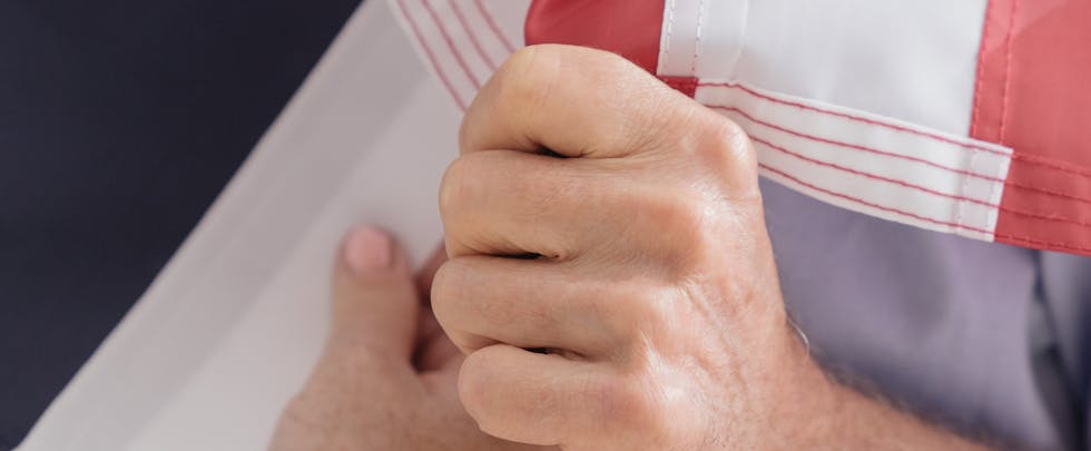 A close-up view of a person holding the American flag, symbolizing patriotism and pride.