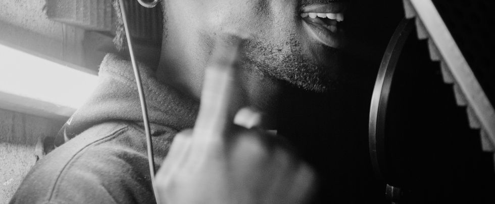 Artistic black and white photo of a male singer in recording studio.