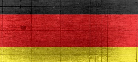 Grungy background designed as flag of Germany on shabby wooden board with measure scale