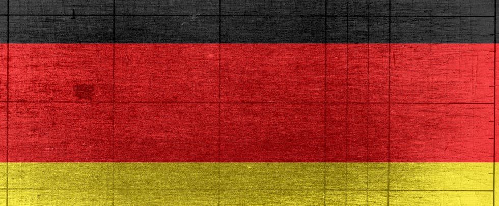 Grungy background designed as flag of Germany on shabby wooden board with measure scale