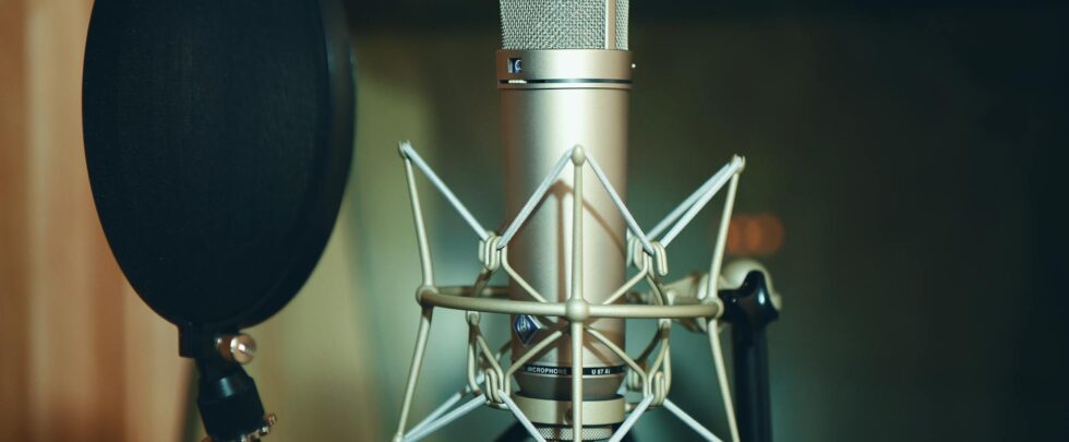 Close-up of a studio microphone with pop filter, perfect for recording.