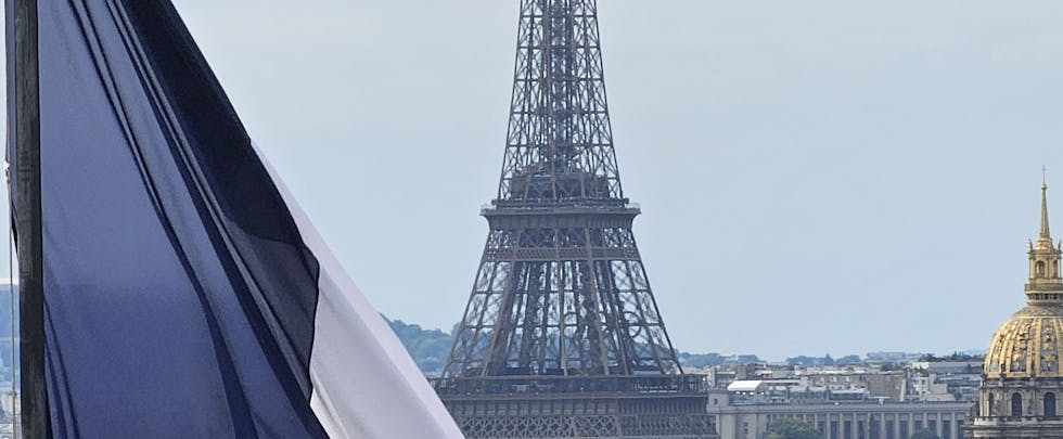 Stunning view of the Eiffel Tower framed by a French flag, capturing the essence of Paris.